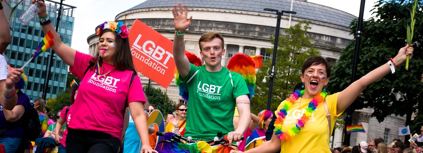 Young people wearing LGBT Foundation t-shirts march in a parade.