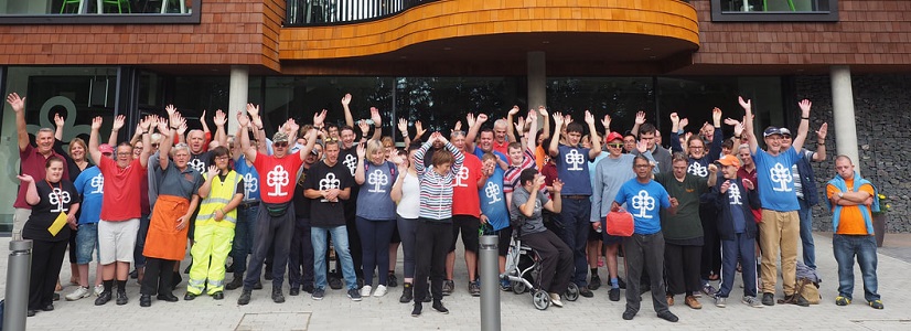 Image of a crowd in front of a new building.