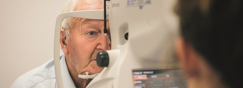 Older person has eyes examined.