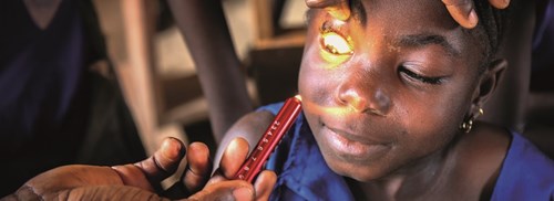 A young girl receives an eye exam
