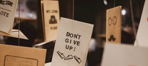 Photo from Lighthouse - an exhibition of supportive messages like 'Don't Give Up',  suspended by wires.